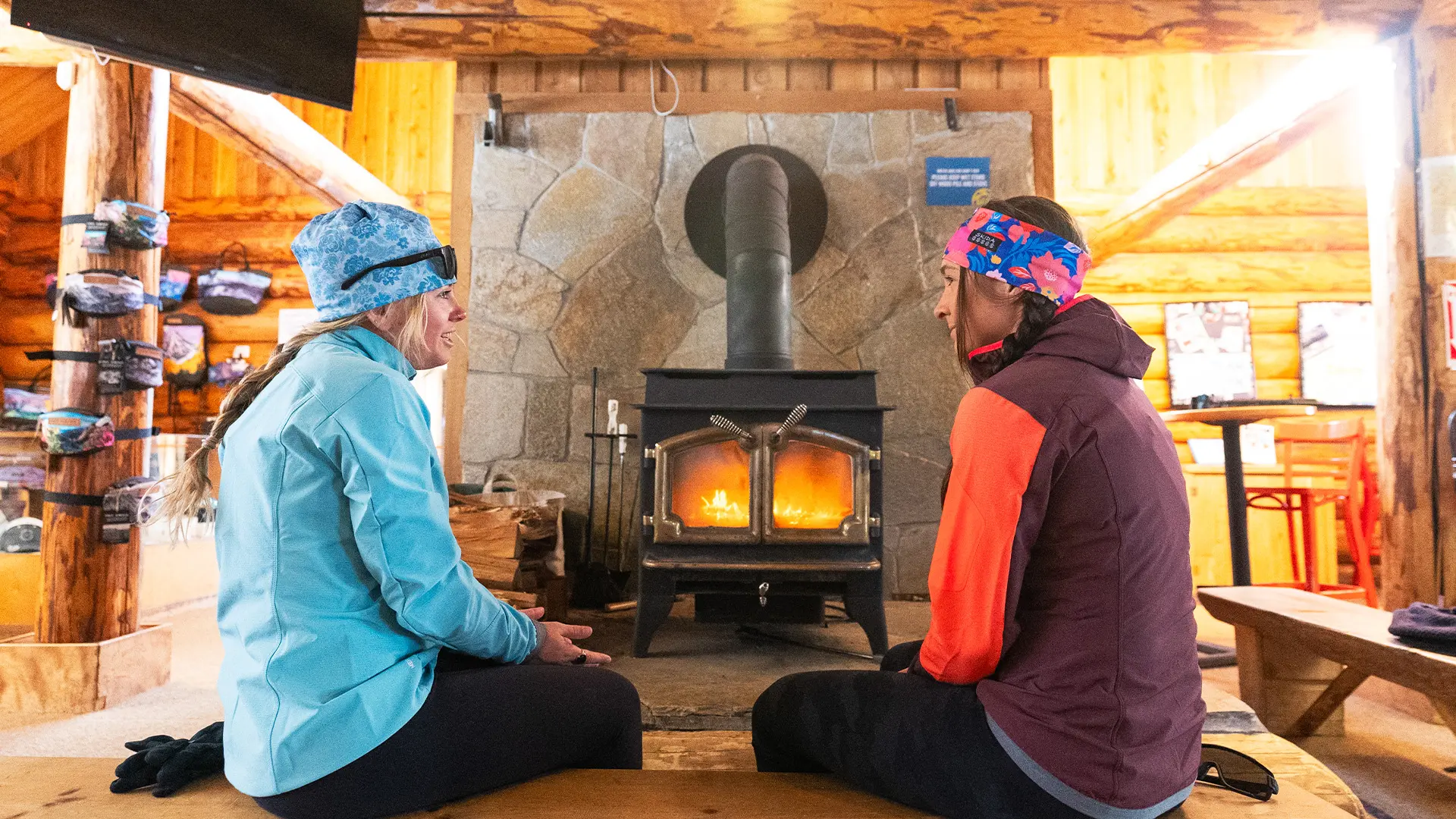 Two Nordic Skiers Sitting by the Fireplace in the Mt. Bachelor Nordic Lodge