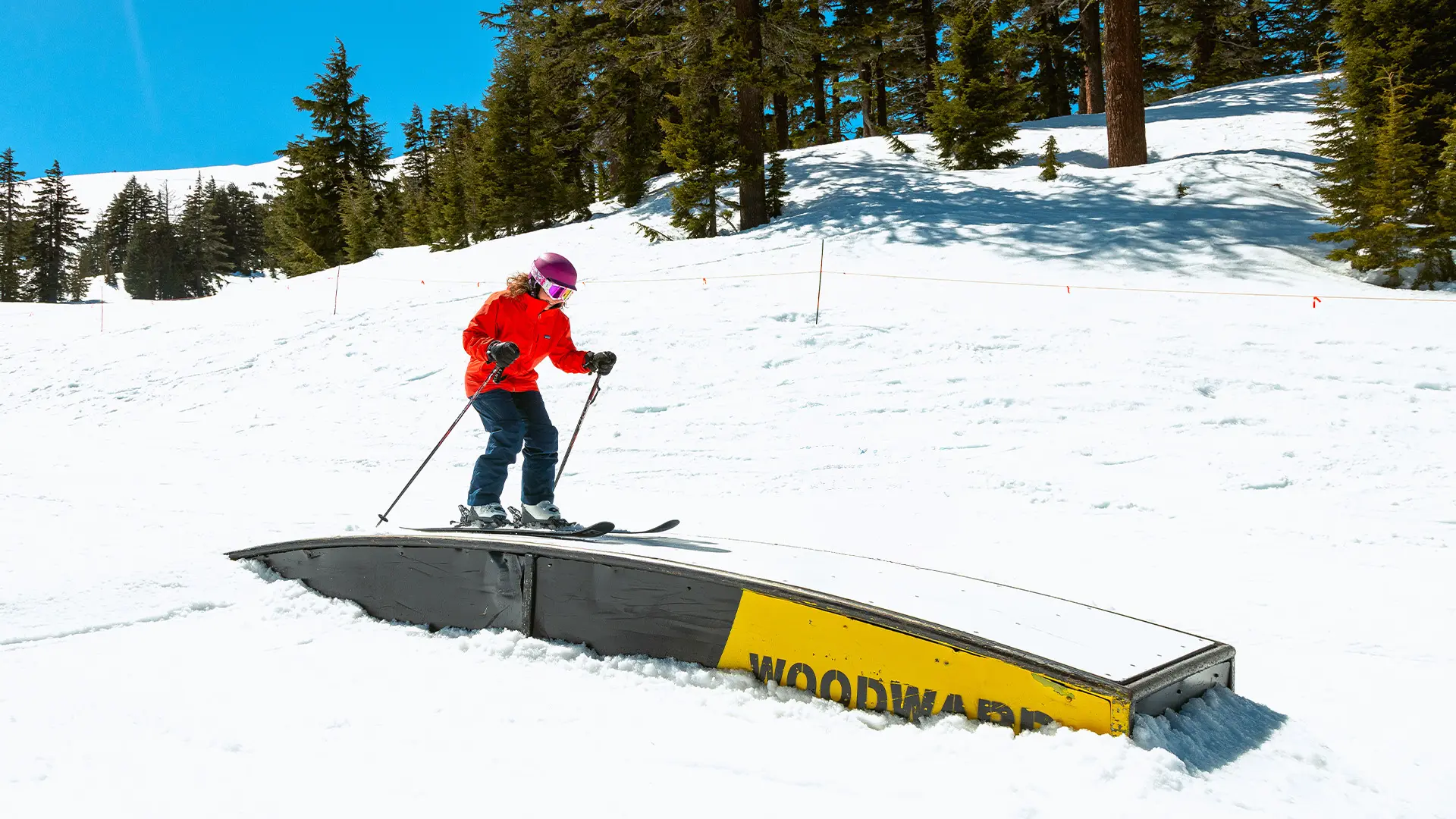 Skier learning to ride rails at Woodward park