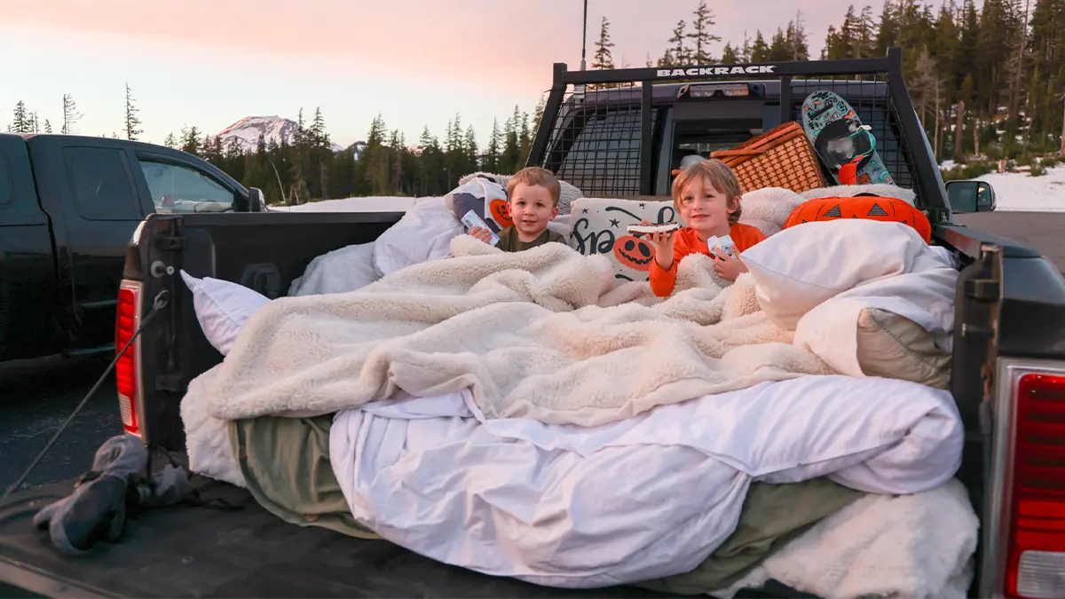 Boys sitting in the bed of a truck for Movies in the Mountains at Mt. Bachelor